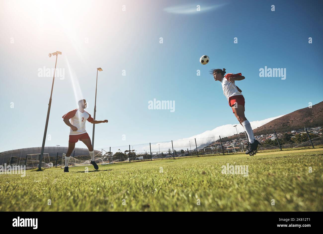 Man, soccer and team in sports training, exercise and workout for fitness on the field in the outdoors. Athletic men playing in football with head Stock Photo