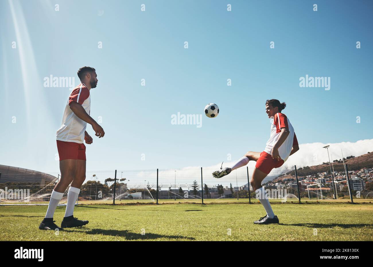 Soccer drill, kick and football workout with people ready for fitness, training and exercise on a field. Sports game, athlete men and fast energy of Stock Photo
