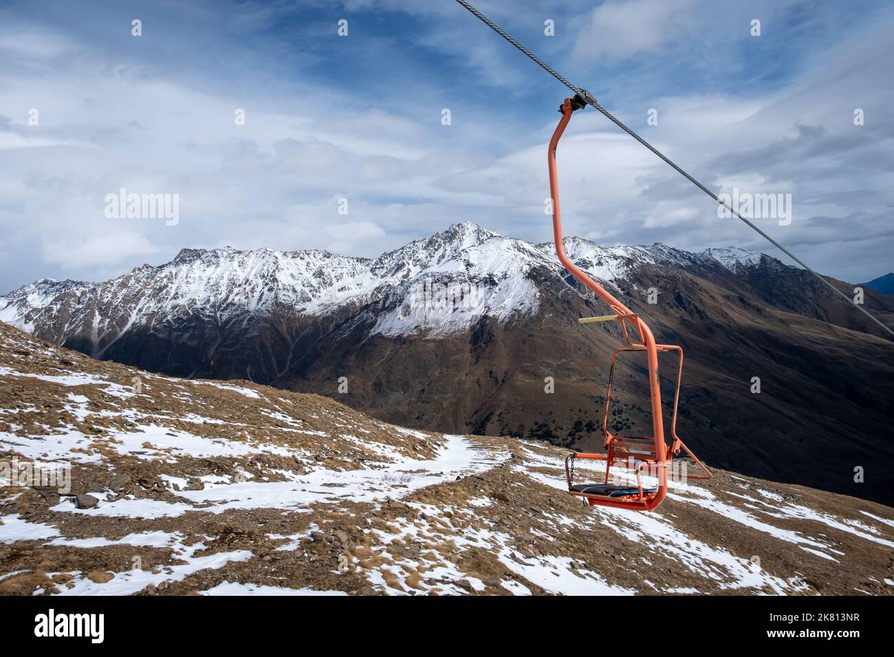 Mountain landscape with a chair of a single-seat cable car Stock Photo