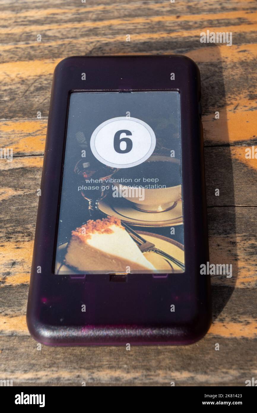 Restaurant or cafe paging system, pager or buzzer on table. Gadget to alert diners when their food is ready to collect. Stock Photo