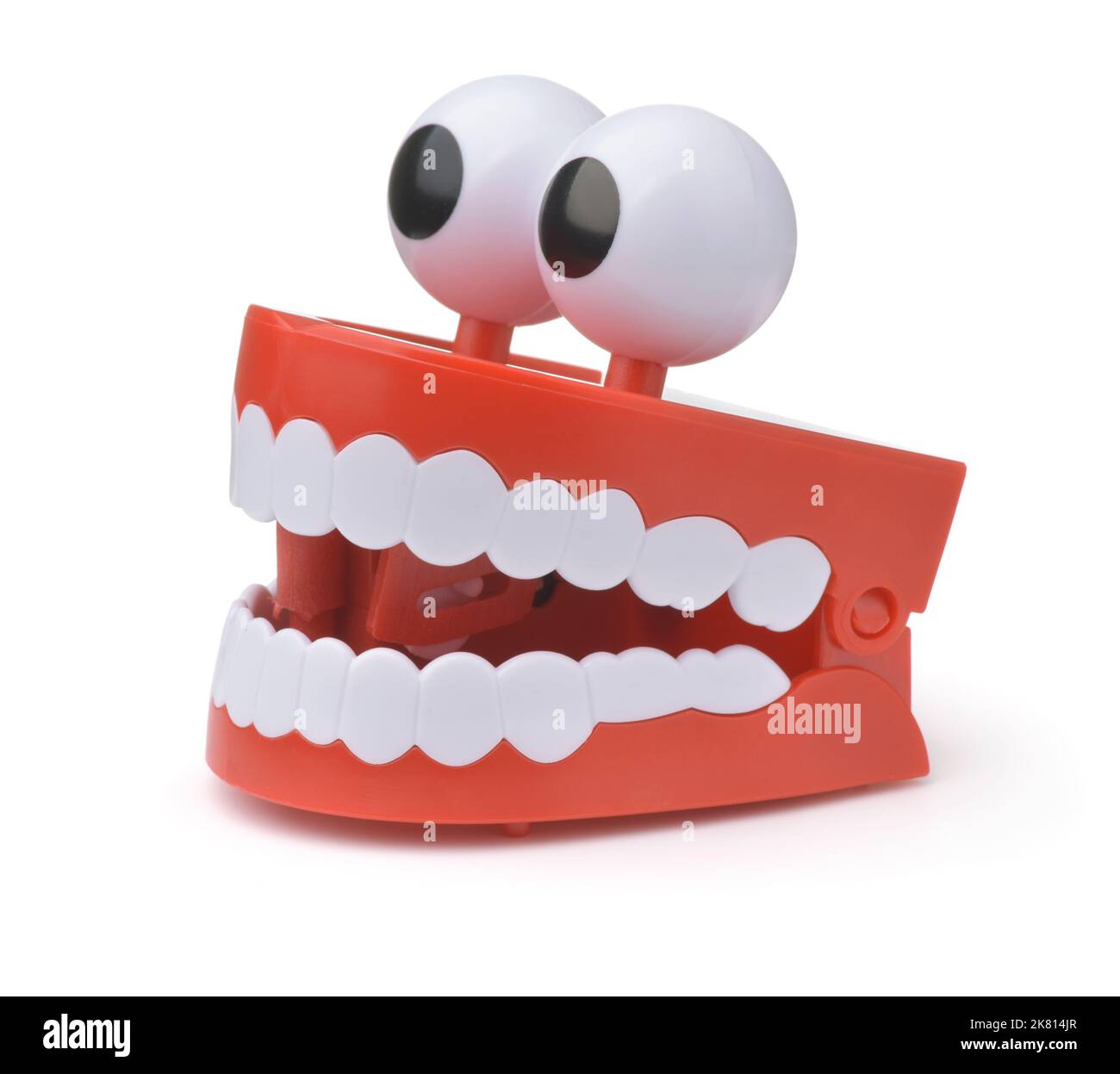 Funny toy clockwork jumping teeth with eyes isolated on white Stock Photo