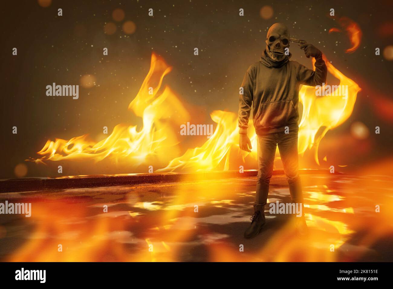 Man with a skull head costume holding gun with a fire background. Halloween concept Stock Photo