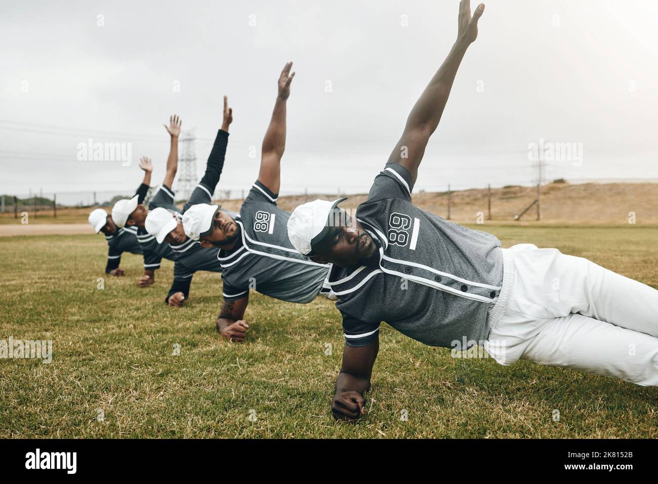 Sports, baseball field and team doing body stretching to prepare for game, competition or fitness workout. Sport, focus or exercise training group of Stock Photo