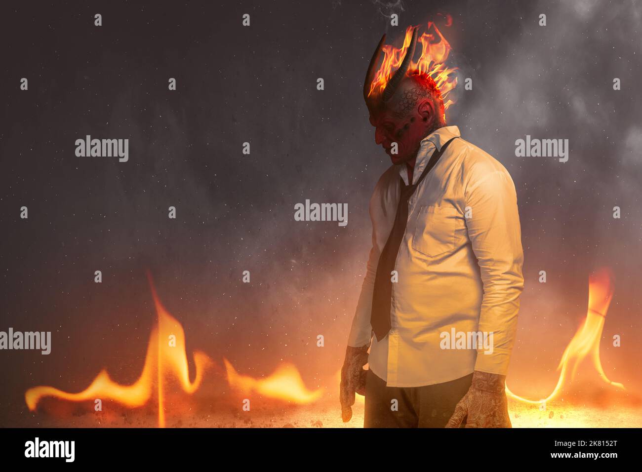 Devilman is standing with fire's background. Halloween concept Stock Photo