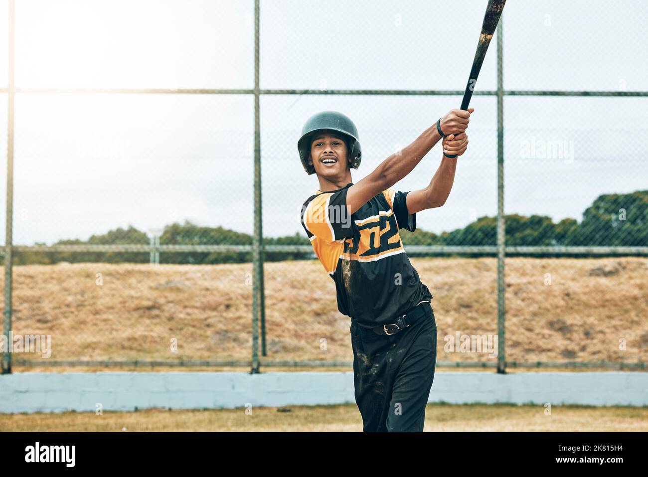 Baseball batter, baseball and man with bat on field at training, game or competition match. Sports, exercise and young male from India with baseball Stock Photo