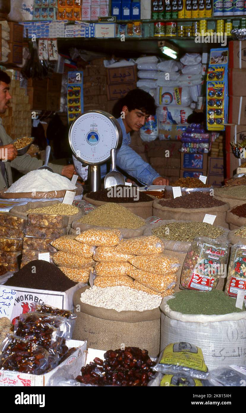 Syria: A general dry goods vendor in the ancient Great Bazaar, Aleppo (1997). Aleppo's Great Bazaar (in Arabic, suq or souq) was rebuilt first by the Egyptian Mamelukes who drove out the Mongols, and then, after 1516, by the Turks who incorporated Aleppo into the Ottoman Empire. During the Syrian Civil War, which started in 2011, Aleppo's historic suqs suffered serious damage.  Aleppo, the second city of Syria is possibly the longest continually inhabited settlement in the world. Its Arabic name, Halab, is mentioned in Semitic texts of the third millennium BCE. Stock Photo
