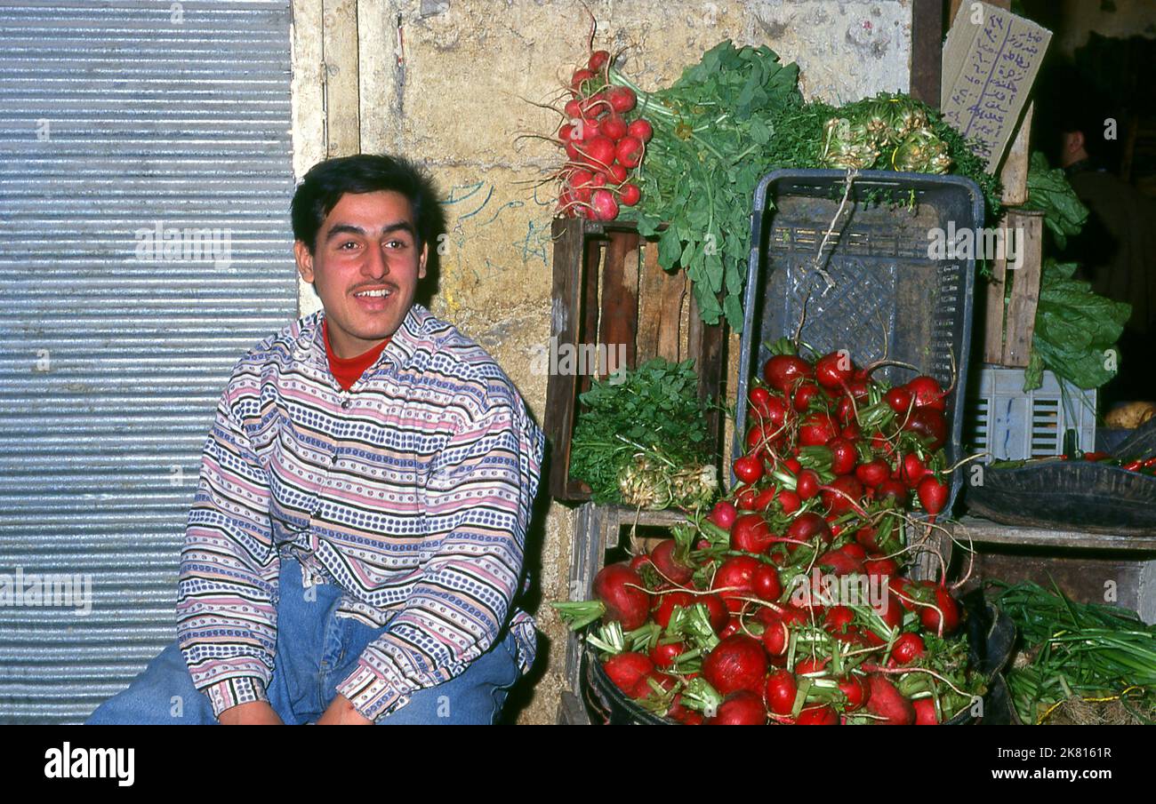 Syria: A radish vendor in the ancient Great Bazaar, Aleppo (1997). Aleppo's Great Bazaar (in Arabic, suq or souq) was rebuilt first by the Egyptian Mamelukes who drove out the Mongols, and then, after 1516, by the Turks who incorporated Aleppo into the Ottoman Empire. During the Syrian Civil War, which started in 2011, Aleppo's historic suqs suffered serious damage.  Aleppo, the second city of Syria is possibly the longest continually inhabited settlement in the world. Its Arabic name, Halab, is mentioned in Semitic texts of the third millennium BCE. Stock Photo