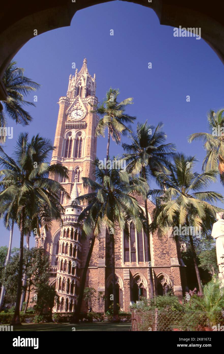 India: The Rajabai Clock Tower and the university library, University of Mumbai, Fort campus, Mumbai, built in so-called‚ Bombay Gothic style. The University of Bombay, as it was originally known, was established in 1857. The Rajabai Tower and library building were designed by Sir George Gilbert Scott and completed in 1878. Stock Photo