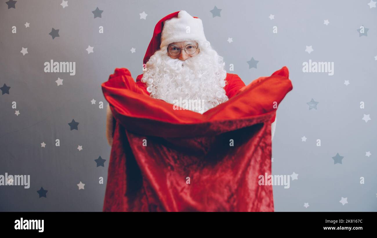 Portrait santa stretching arms bag hi-res stock photography and images ...