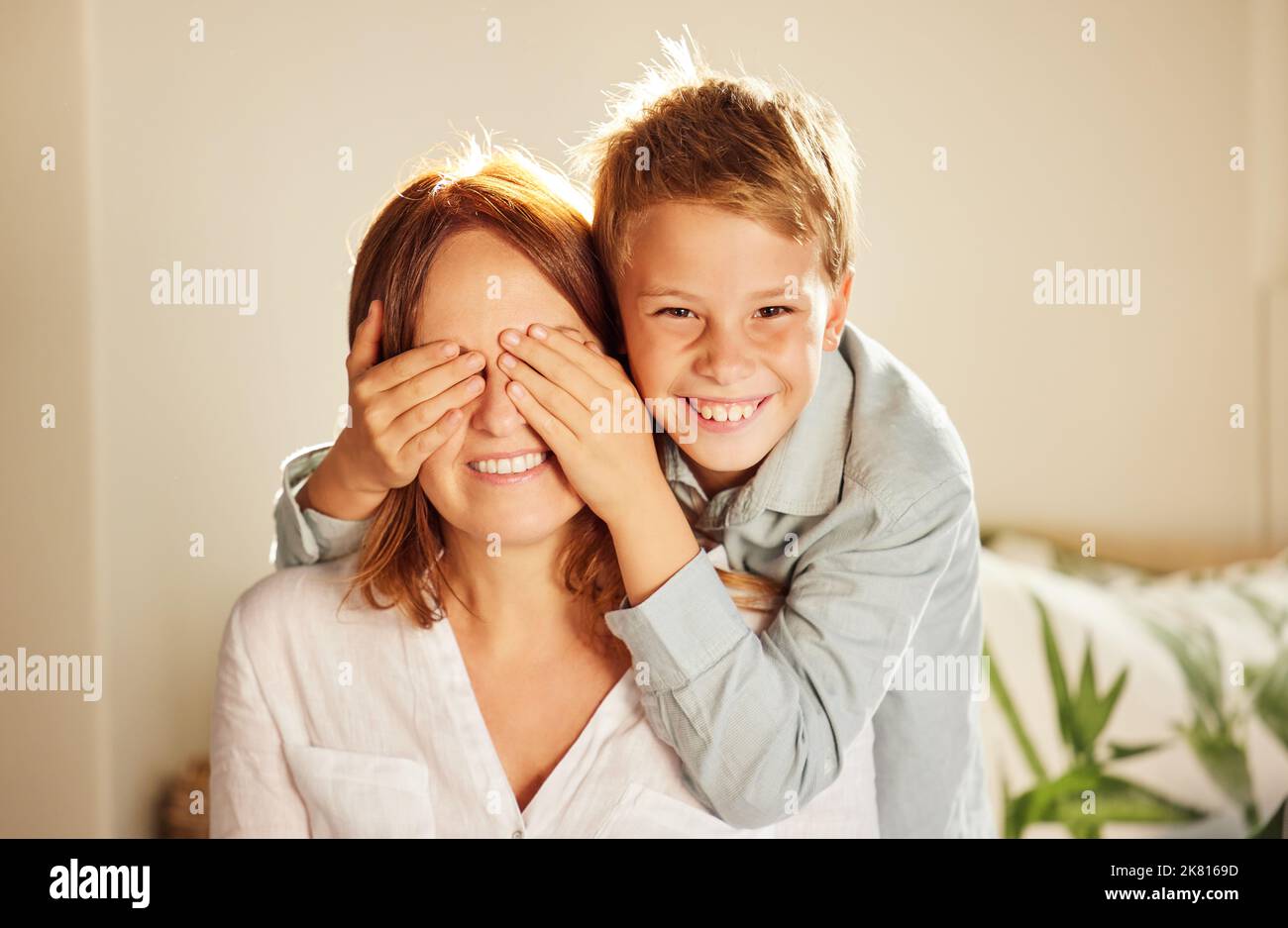 Close your eyes. an adorable little boy bonding with his mother at home