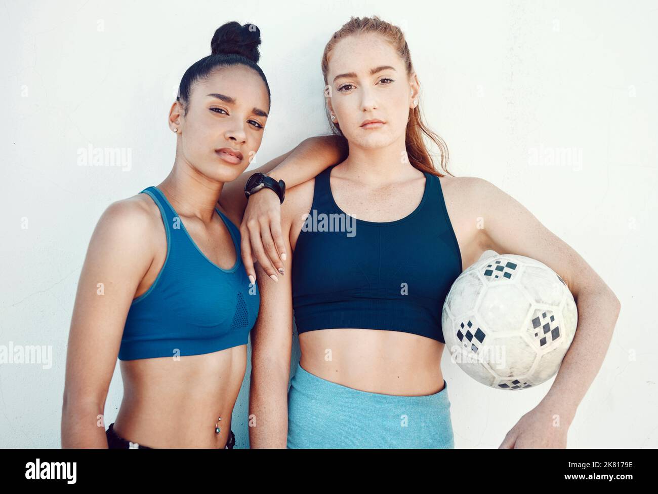 Soccer, women and portrait of friends with a ball standing by a white background for training. Fitness, football and girl athletes ready for a sports Stock Photo