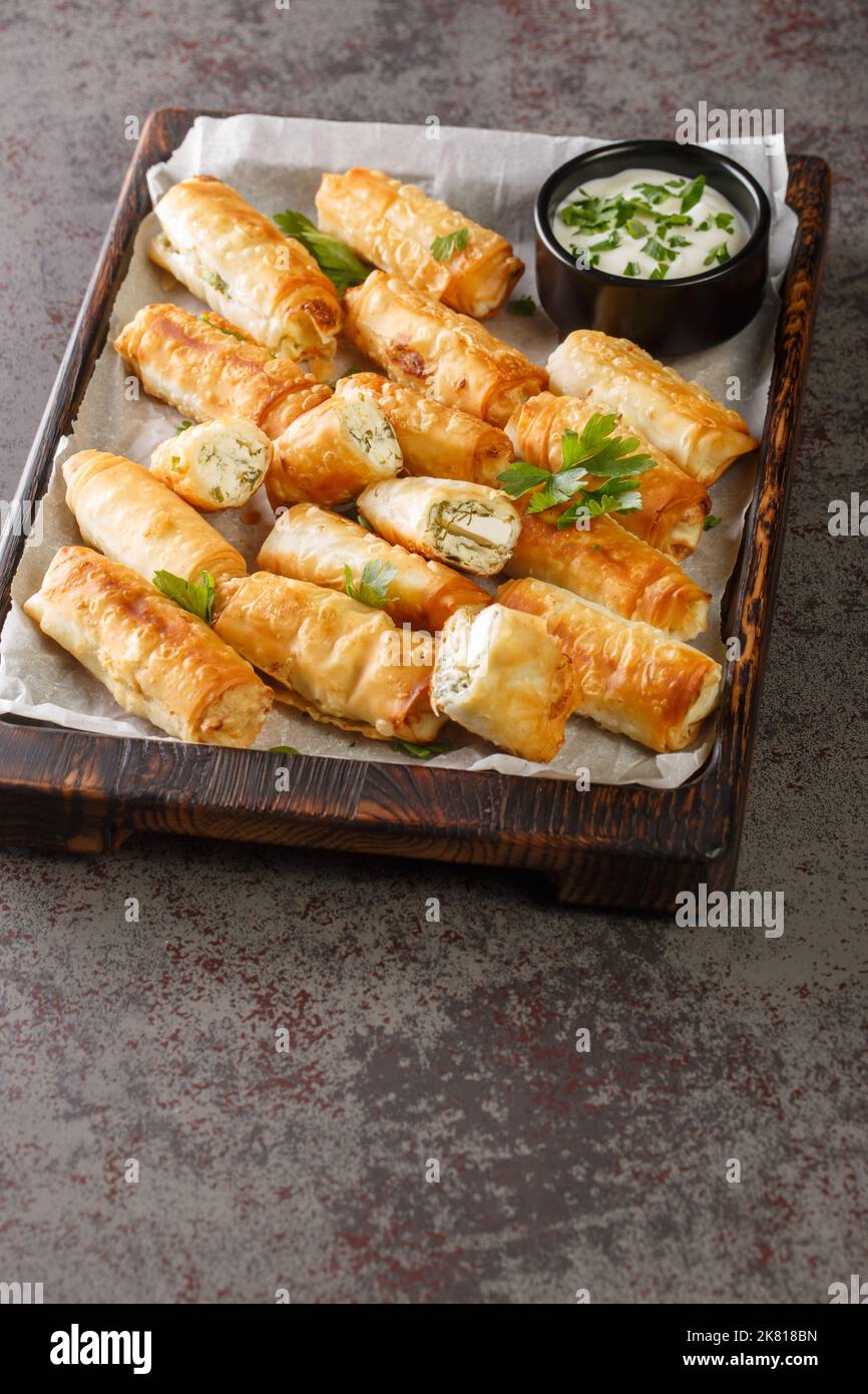 sigara boregi is a famous Turkish deep-fried pastry crispy rolls of thin dough are stuffed with a creamy mixture of cheese and parsley closeup on the Stock Photo