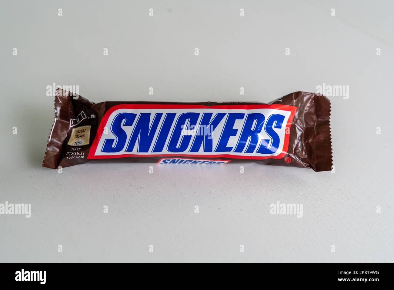 An Unopened Single Snickers - formerly Marathon - Bar pictured on plain background Stock Photo