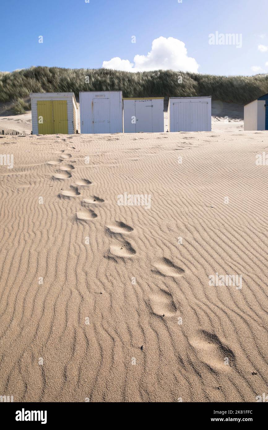 beach cabins and footprints on the beach in Oostkapelle on the peninsula Walcheren, Zeeland, Netherlands. Strandhaeuschen und Fussspuren am Strand von Stock Photo