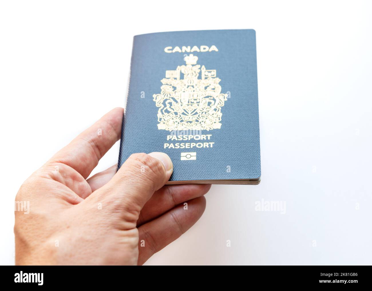 A handholding passport isolated on a white background Stock Photo Alamy