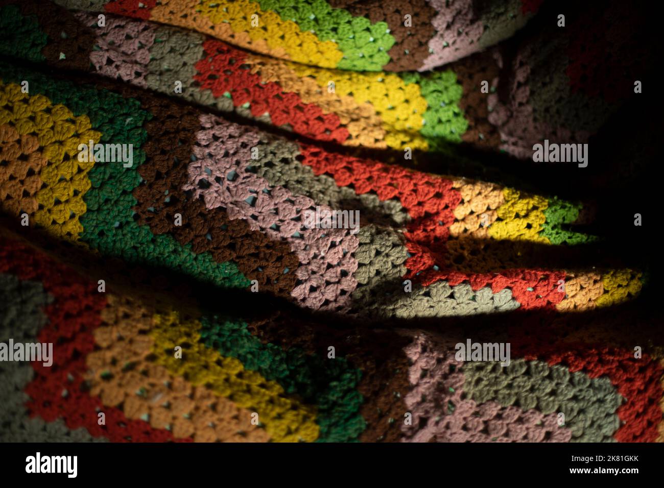 Colored plaid. Cozy blanket. Bedspread of thick fabric fibers. Woven