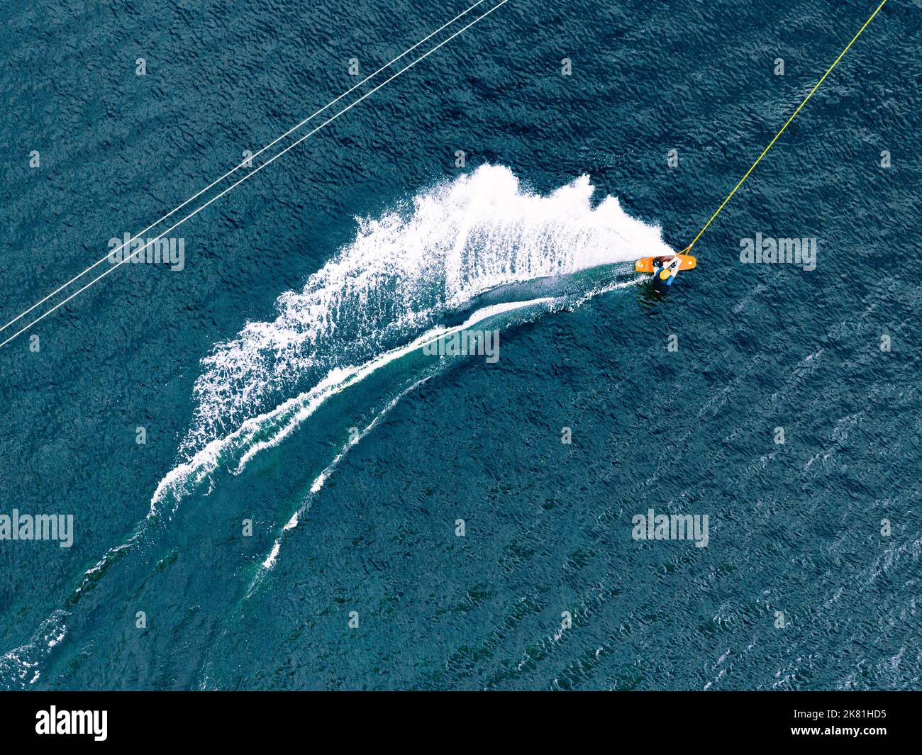 Aerial wakeboarding. Top view of awakeboard rider in wake cable park