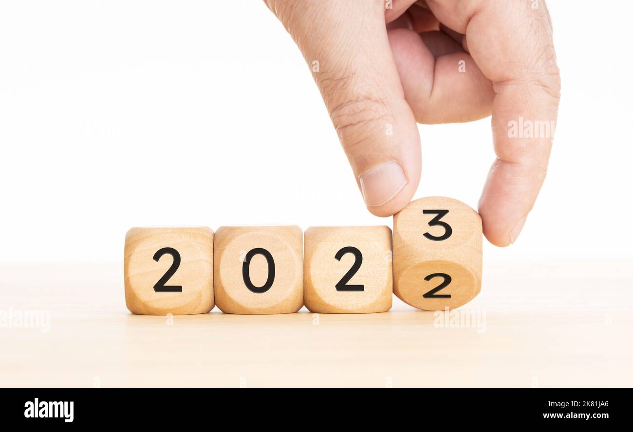 Hand changing Wooden Blocks with 2022 to 2023 year. Copy space Stock Photo