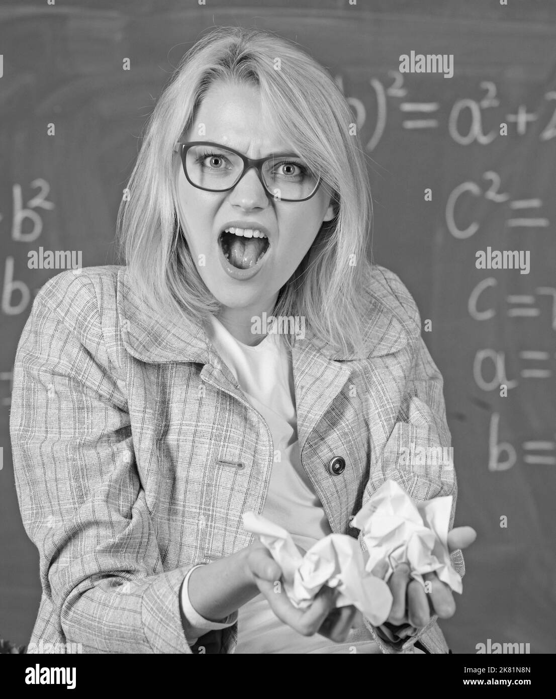 Woman teacher holds crumpled pieces of paper. Fed up of fails. Trial