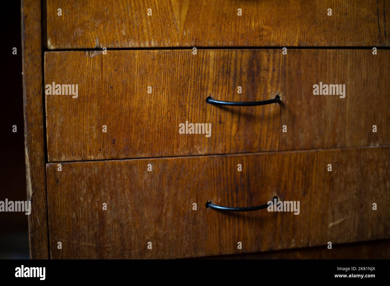 Drawer in table. Wooden boxes in room. Handles on board. Interior details. Stock Photo