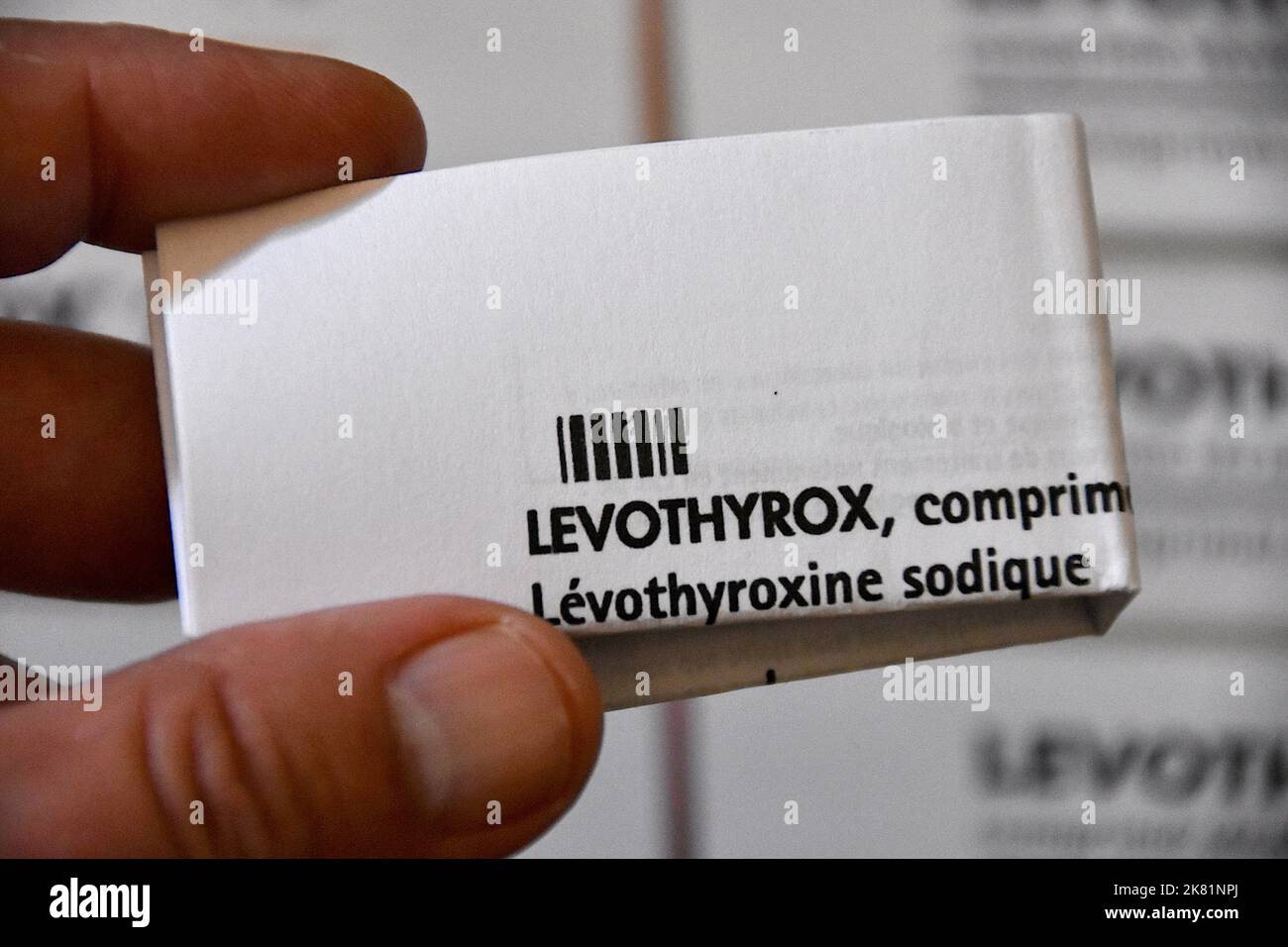 Marseille, France. 19th Oct, 2022. The folded leaflet of the Levothyrox drug is seen held in a person's hand. The pharmaceutical company Merck, which markets Levothyrox, has been indicted for aggravated deception in connection with the change in the formula of the drug. Several thousand patients treated with this new formula of the drug indicated in the treatment of thyroid disorders have complained of heavy side effects and have filed a complaint against the German laboratory. Credit: SOPA Images Limited/Alamy Live News Stock Photo