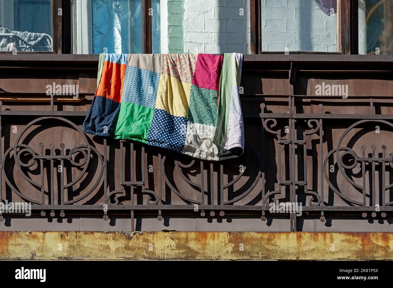 Rusty balcony balustrade with colorful rug on Stock Photo