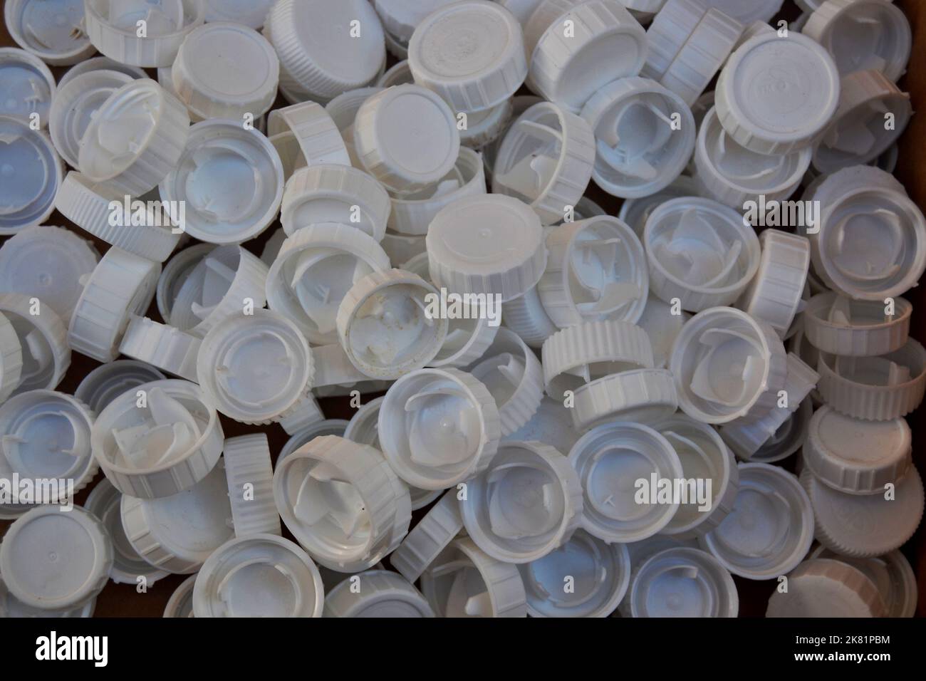 Background made with many white plastic bottle caps Stock Photo