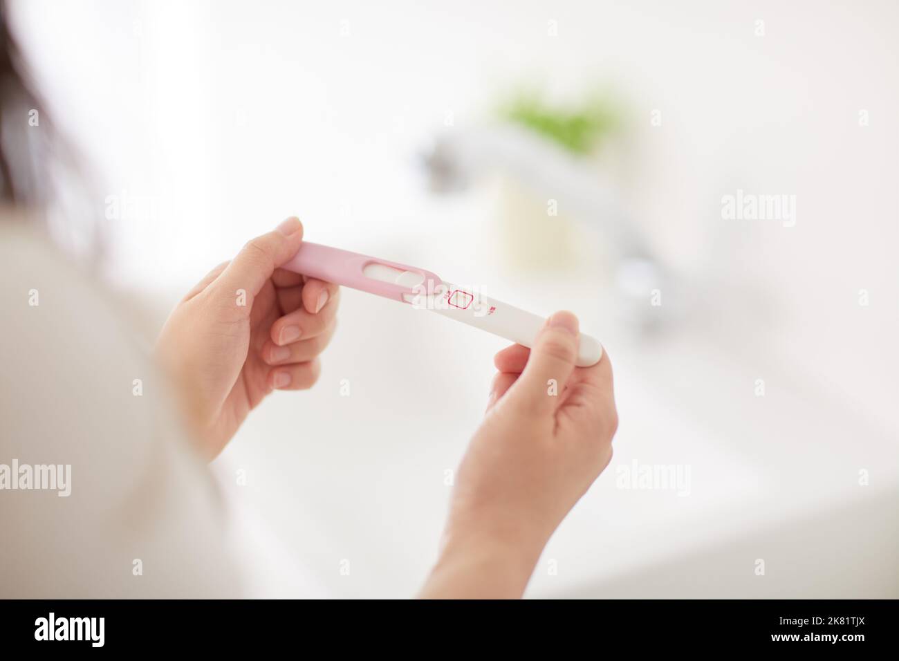 Japanese woman with pregnancy test Stock Photo Alamy