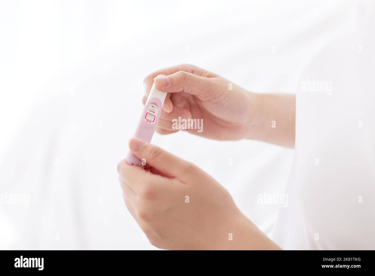 Japanese woman with pregnancy test Stock Photo Alamy