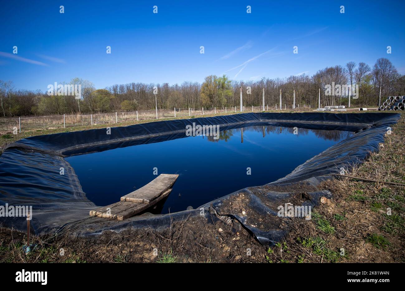 Insulated leachate pond with dirty water, part of landfill Stock Photo