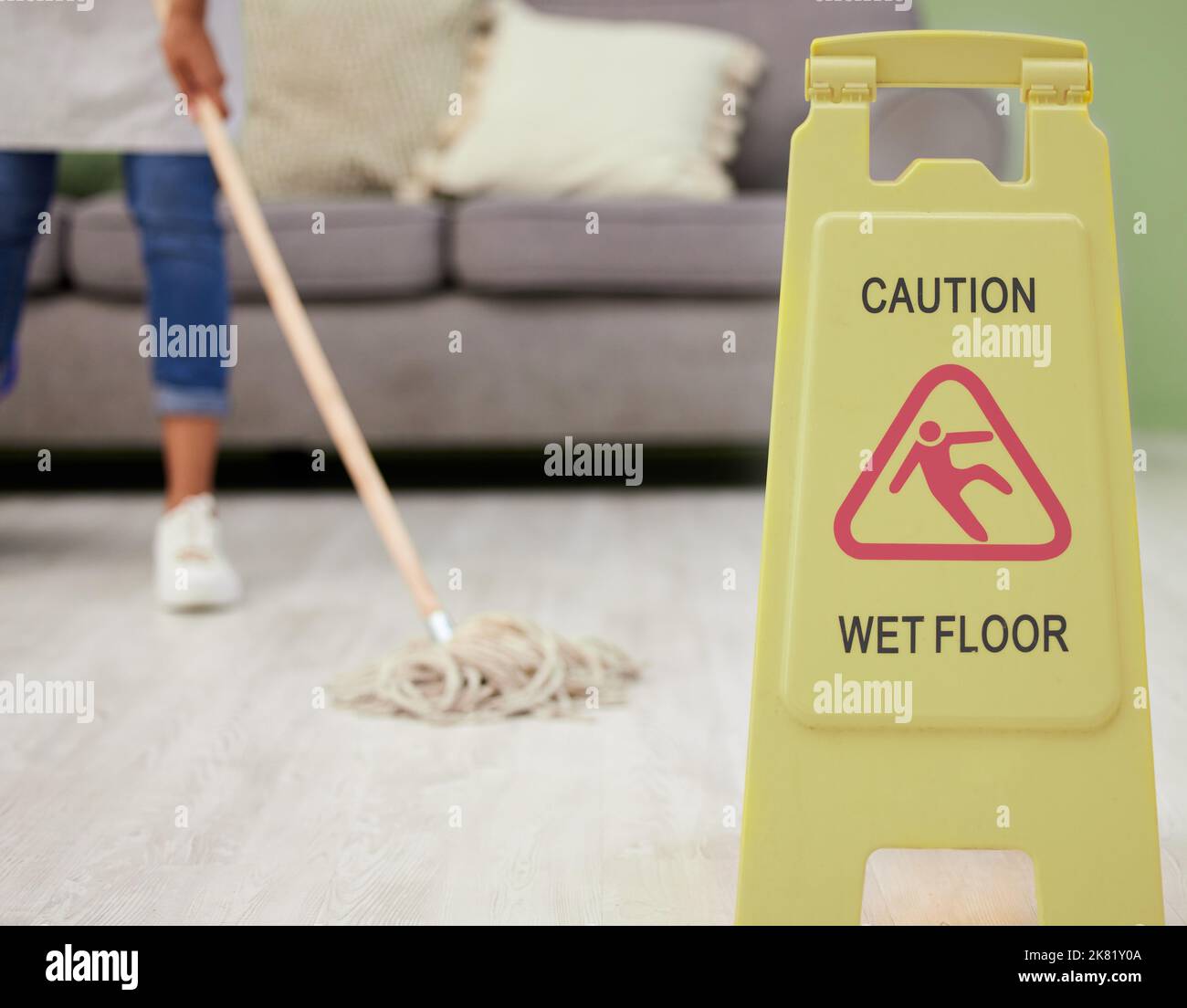 Dont slip. an unrecognizable woman mopping her living room at home. Stock Photo
