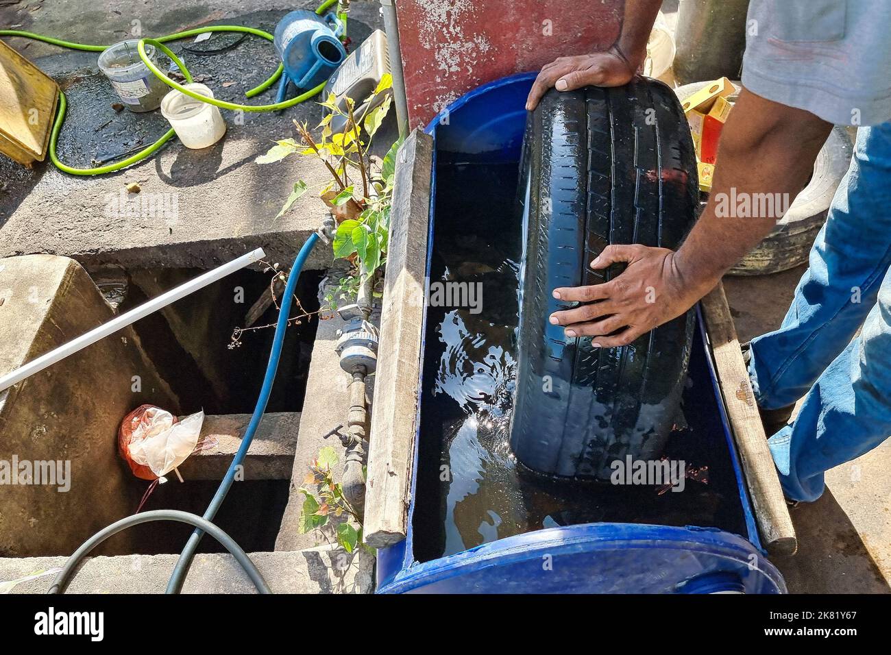 Worker submerge tyre into water container for bubble to check point of