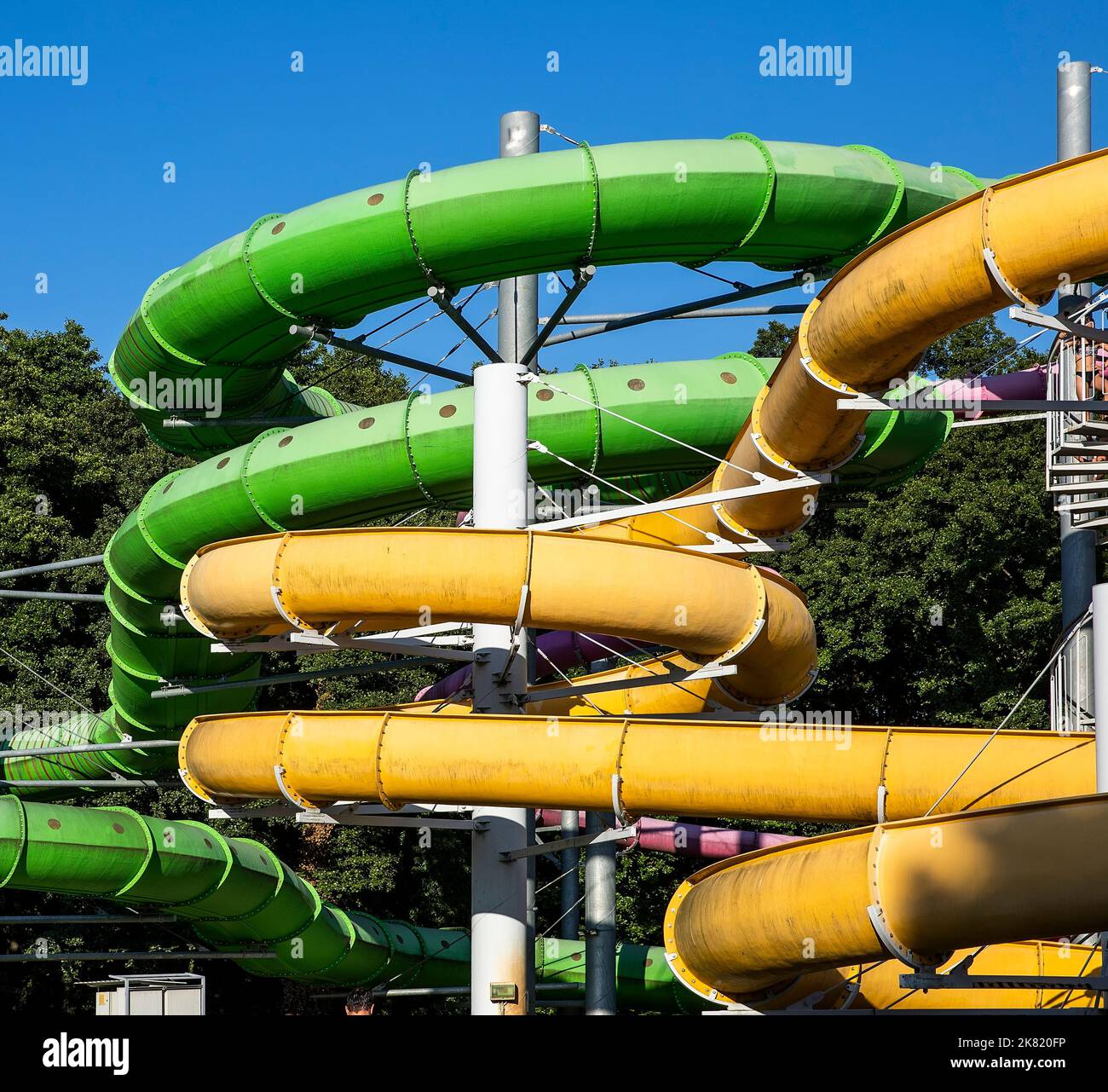 Yellow and green water slide in aquapark Stock Photo - Alamy