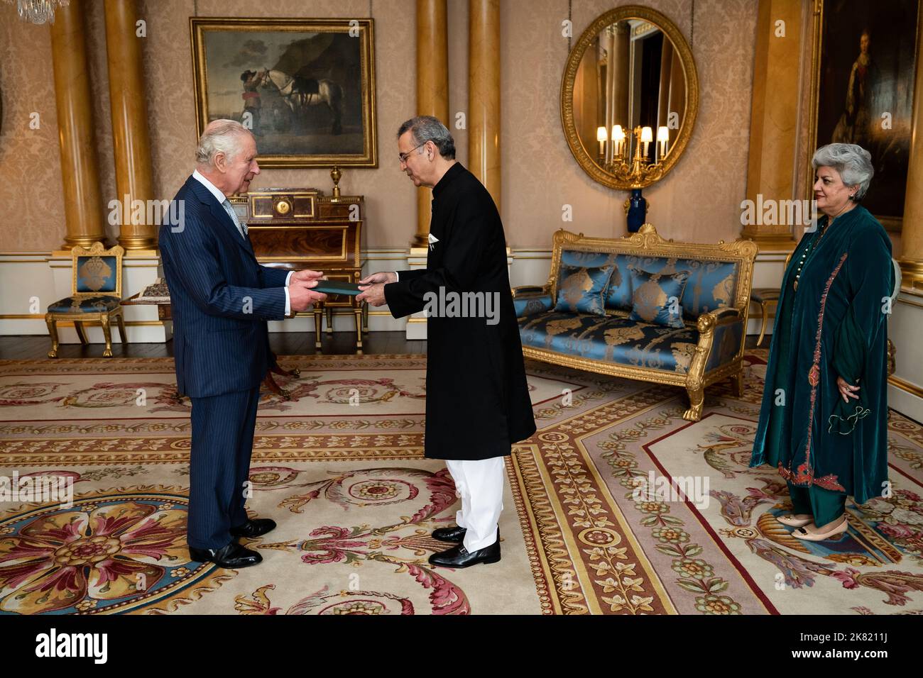 King Charles III during an audience with Mr Moazzam Ahmad Khan and presented the Letters of Recall of his predecessor and his own Letters of Commission as High Commissioner for the Islamic Republic of Pakistan in London accompanied by Mrs. Moazzam at Buckingham Palace, London. Picture date: Thursday October 20, 2022. Stock Photo