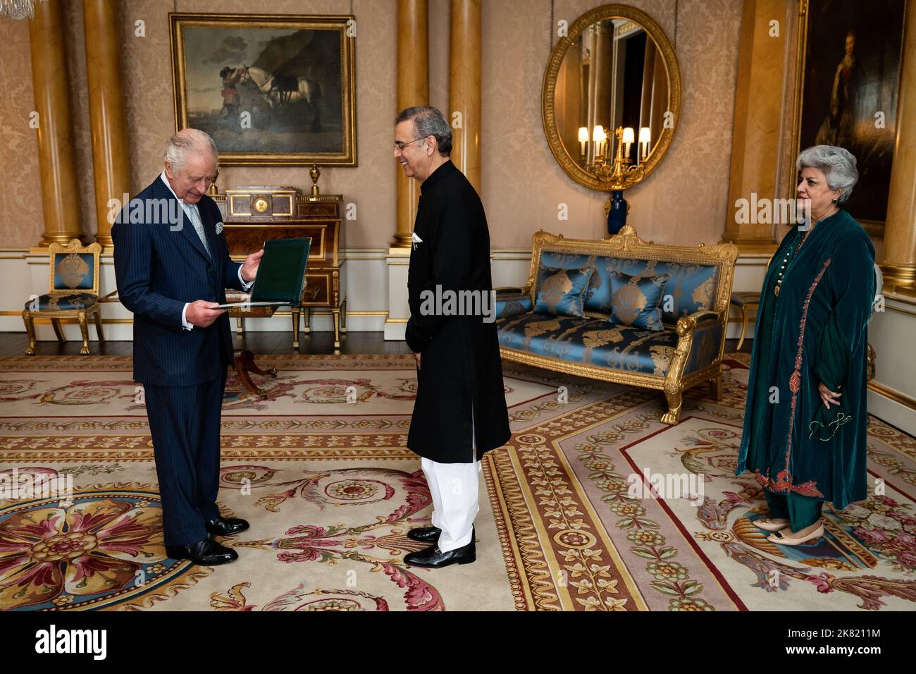 King Charles III during an audience with Mr Moazzam Ahmad Khan and presented the Letters of Recall of his predecessor and his own Letters of Commission as High Commissioner for the Islamic Republic of Pakistan in London accompanied by Mrs. Moazzam at Buckingham Palace, London. Picture date: Thursday October 20, 2022. Stock Photo