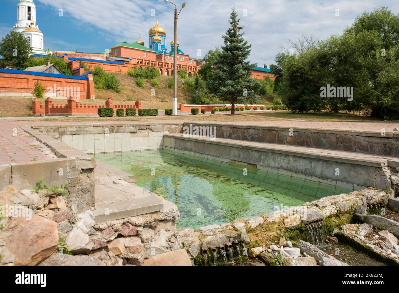 Open pool with spring water at the walls of the Zadonsky Nativity of ...