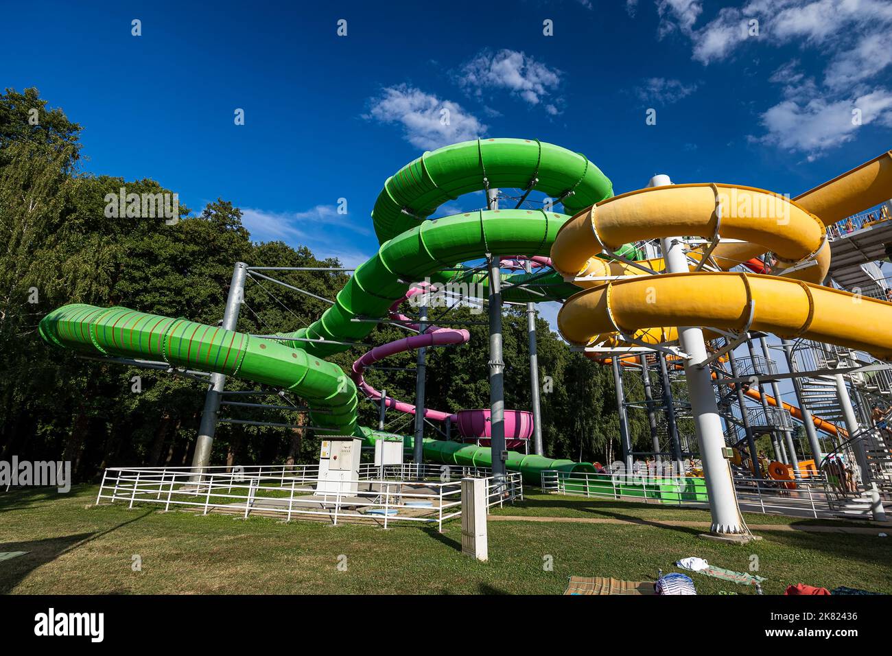 Green and yellow water slide in aquapark Stock Photo Alamy