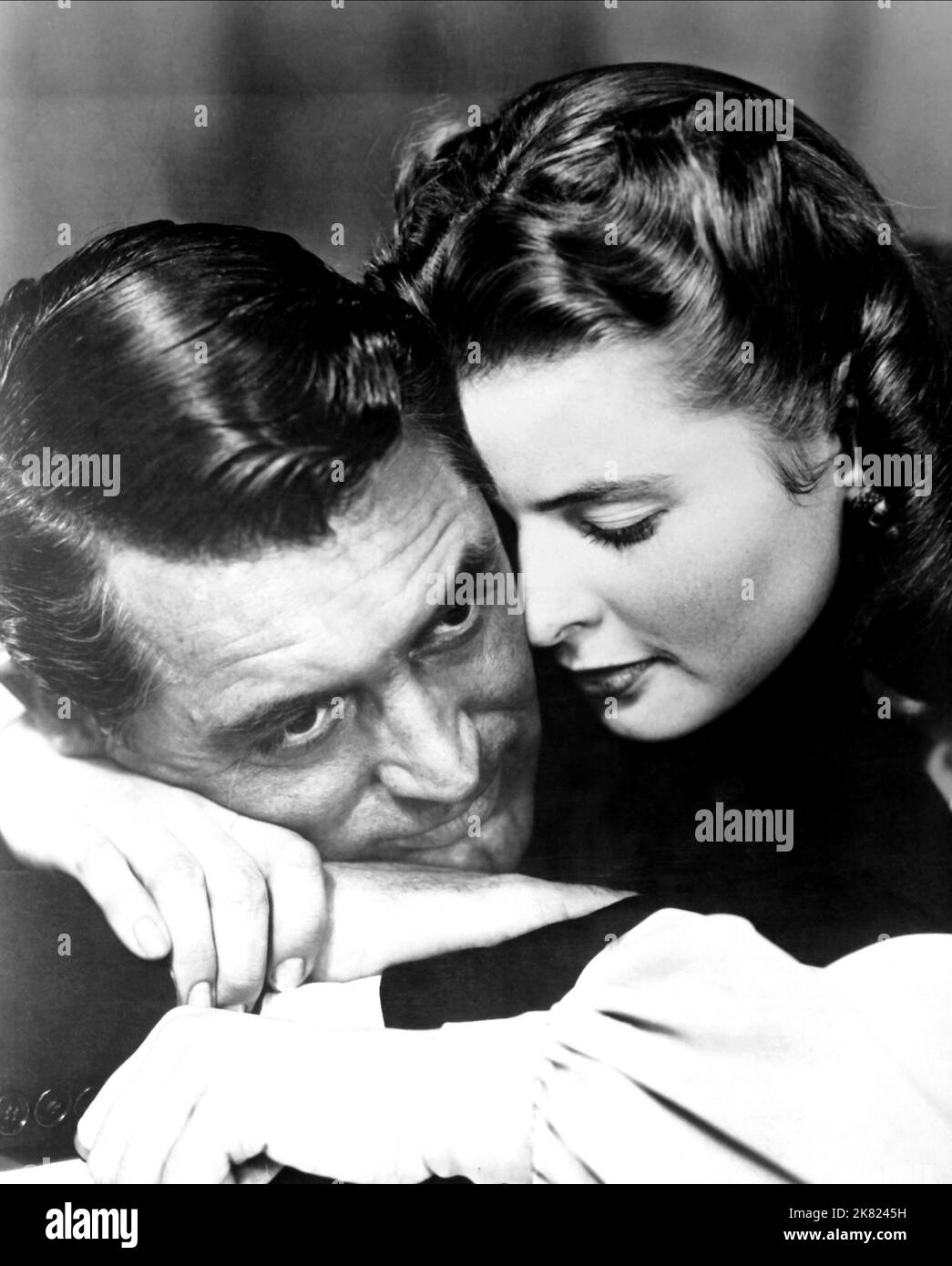 Cary Grant & Ingrid Bergman Film: Notorious (USA 1964) Characters: T.R. Devlin, Alicia Huberman  Director: Alfred Hitchcock 15 August 1946   **WARNING** This Photograph is for editorial use only and is the copyright of RKO and/or the Photographer assigned by the Film or Production Company and can only be reproduced by publications in conjunction with the promotion of the above Film. A Mandatory Credit To RKO is required. The Photographer should also be credited when known. No commercial use can be granted without written authority from the Film Company. Stock Photo