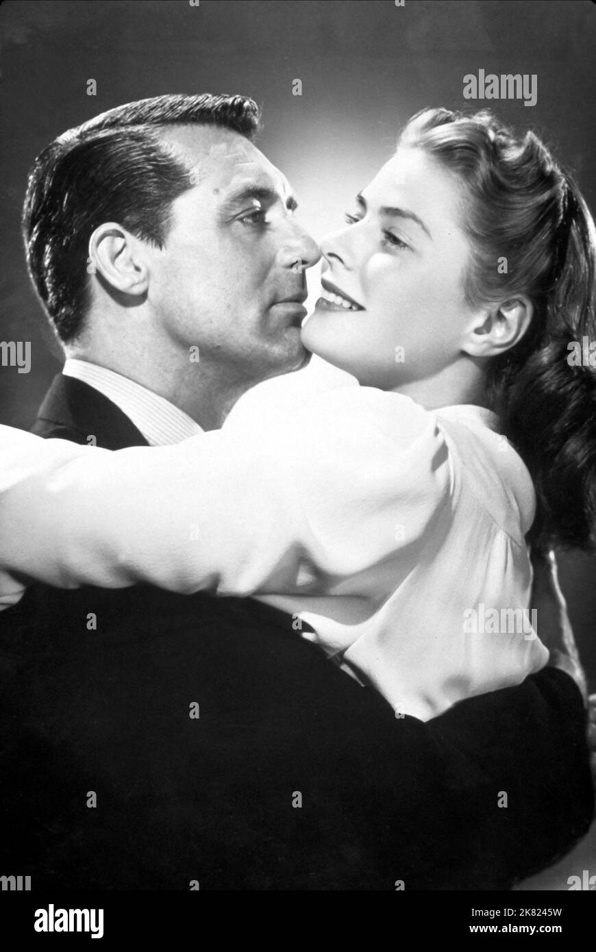 Cary Grant & Ingrid Bergman Film: Notorious (USA 1964) Characters: T.R. Devlin, Alicia Huberman  Director: Alfred Hitchcock 15 August 1946   **WARNING** This Photograph is for editorial use only and is the copyright of RKO and/or the Photographer assigned by the Film or Production Company and can only be reproduced by publications in conjunction with the promotion of the above Film. A Mandatory Credit To RKO is required. The Photographer should also be credited when known. No commercial use can be granted without written authority from the Film Company. Stock Photo
