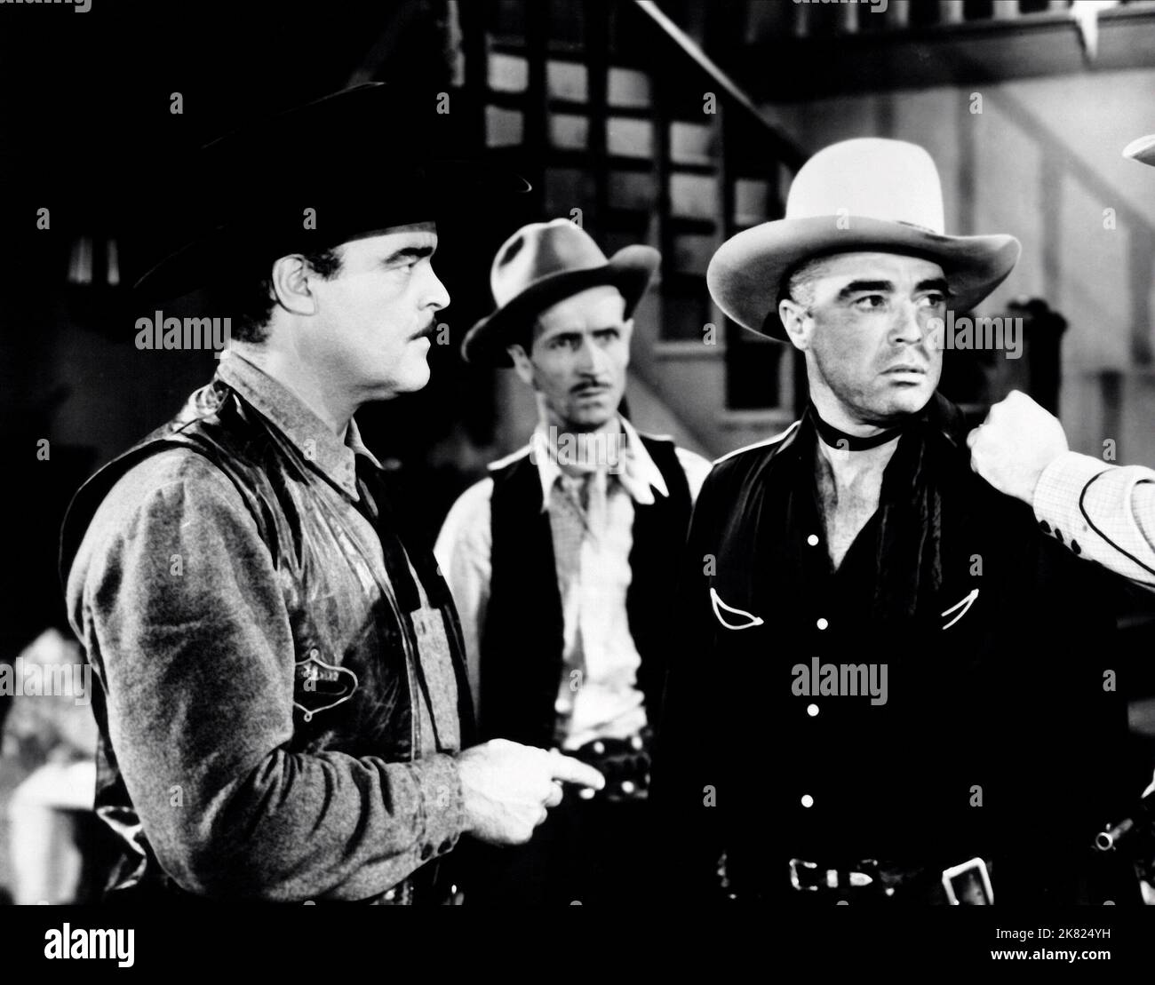 John Merton, Riley Hill & Johnny Mack Brown Film: Border Bandits (1940) Characters: Henchman Spike, Steve Halliday, Marshal Nevada  Director: Lambert Hillyer 02 January 1946   **WARNING** This Photograph is for editorial use only and is the copyright of MONOGRAM PICTURES and/or the Photographer assigned by the Film or Production Company and can only be reproduced by publications in conjunction with the promotion of the above Film. A Mandatory Credit To MONOGRAM PICTURES is required. The Photographer should also be credited when known. No commercial use can be granted without written authority Stock Photo