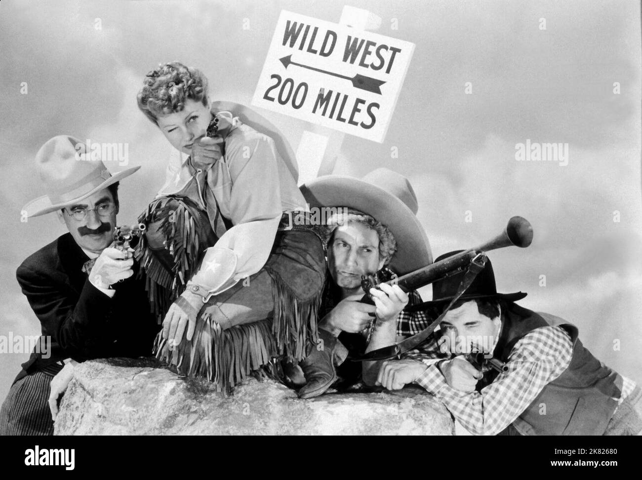 Groucho Marx, Diana Lewis, Harpo Marx & Chico Marx Film: Go West; Marx Brothers: Go West (USA 1940) Characters: S. Quentin Quale,  Eve Wilson, 'Rusty' Panello, Joe Panello  Director: Edward Buzzell 06 December 1940   **WARNING** This Photograph is for editorial use only and is the copyright of MGM and/or the Photographer assigned by the Film or Production Company and can only be reproduced by publications in conjunction with the promotion of the above Film. A Mandatory Credit To MGM is required. The Photographer should also be credited when known. No commercial use can be granted without writt Stock Photo