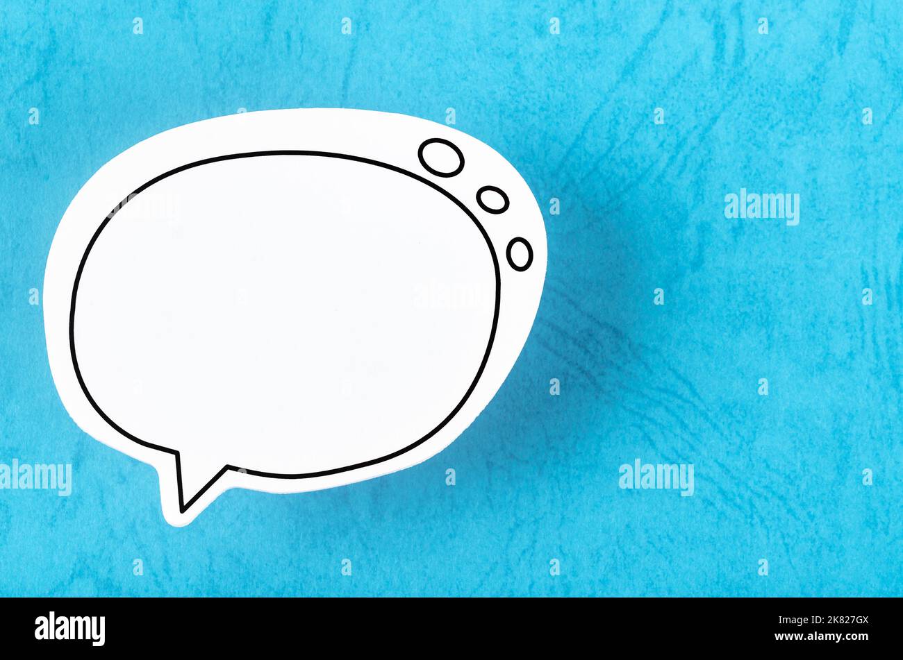 Speech bubble with copy space communication talking speaking concepts on blue background. Stock Photo