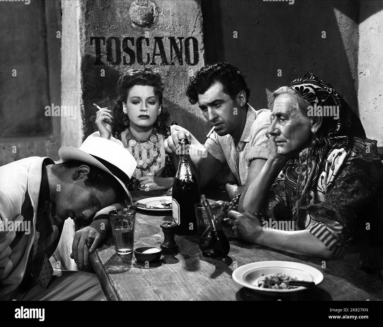 Peter Glenville, Phyllis Calvert, Stewart Granger & Nancy Price Film: Madonna Of The Seven Moons (1947) Characters: Sandro Barucci,Maddalena Labardi (Rosanna),Nino Barucci & Mama Barucci  Director: Arthur Crabtree 22 January 1945   **WARNING** This Photograph is for editorial use only and is the copyright of UNIVERSAL PICTURES and/or the Photographer assigned by the Film or Production Company and can only be reproduced by publications in conjunction with the promotion of the above Film. A Mandatory Credit To UNIVERSAL PICTURES is required. The Photographer should also be credited when known. N Stock Photo