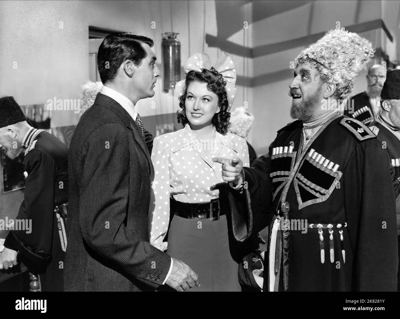 Cary Grant, Alexis Smith & Monty Woolley Film: Night And Day (1946) Characters: Cole Porter, Linda Lee Porter, Himself  Director: Michael Curtiz 02 July 1946   **WARNING** This Photograph is for editorial use only and is the copyright of WARNER BROS and/or the Photographer assigned by the Film or Production Company and can only be reproduced by publications in conjunction with the promotion of the above Film. A Mandatory Credit To WARNER BROS is required. The Photographer should also be credited when known. No commercial use can be granted without written authority from the Film Company. Stock Photo