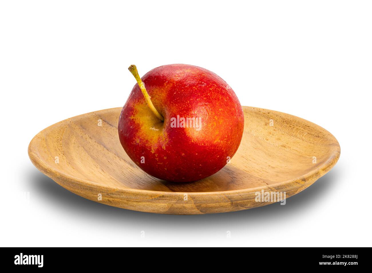 Side view of single fresh ripe crisp snack-size mini apple or little apple or small apple in wooden plate on white background with clipping path. Stock Photo