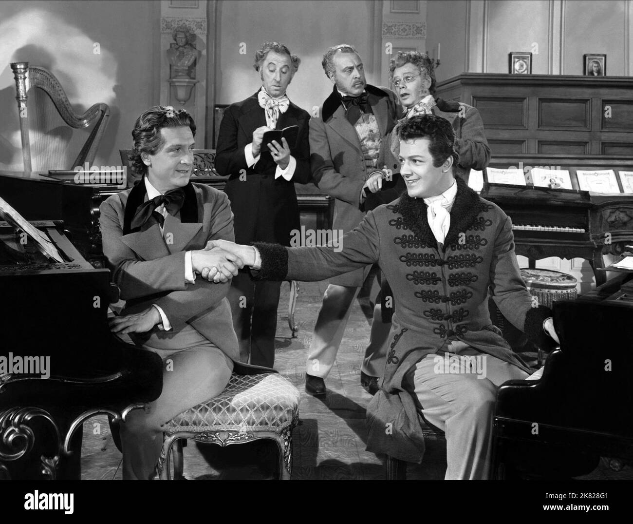Stephen Bekassy, Cornel Wilde & Paul Muni Film: A Song To Remember (1945) Characters: Franz Liszt, Frederic Chopin, Prof. Joseph Elsner  Director: Charles Vidor 18 January 1945   **WARNING** This Photograph is for editorial use only and is the copyright of COLUMBIA and/or the Photographer assigned by the Film or Production Company and can only be reproduced by publications in conjunction with the promotion of the above Film. A Mandatory Credit To COLUMBIA is required. The Photographer should also be credited when known. No commercial use can be granted without written authority from the Film C Stock Photo