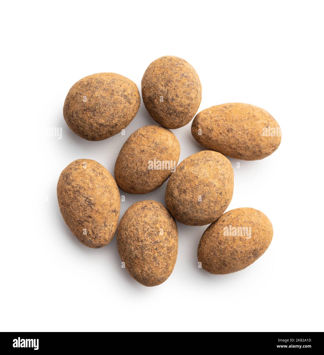 Almonds in chocolate coated in cocoa powder isolated on a white