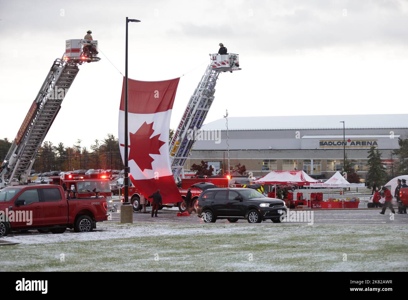 Barrie Fire Department members prepare to raise a Canadian flag prior