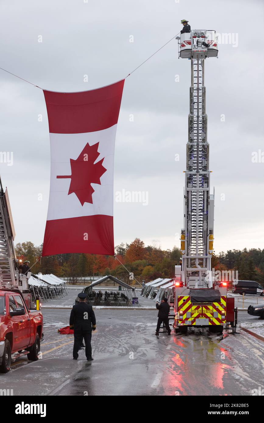 Barrie Fire Department members prepare to raise a Canadian flag prior