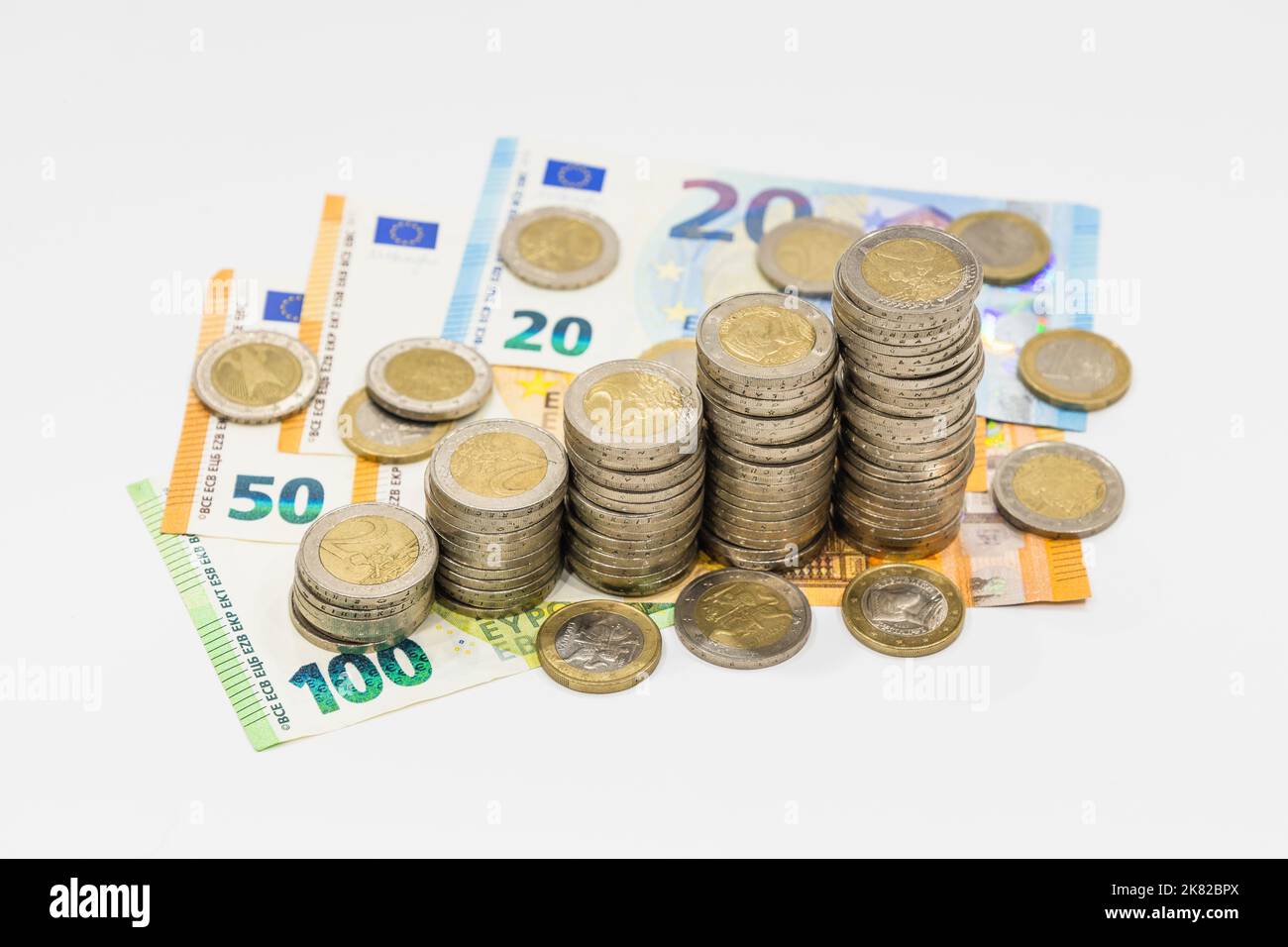 Stack of ascending Euro coins on euro money banknotes. Finance banking and saving concept Stock Photo